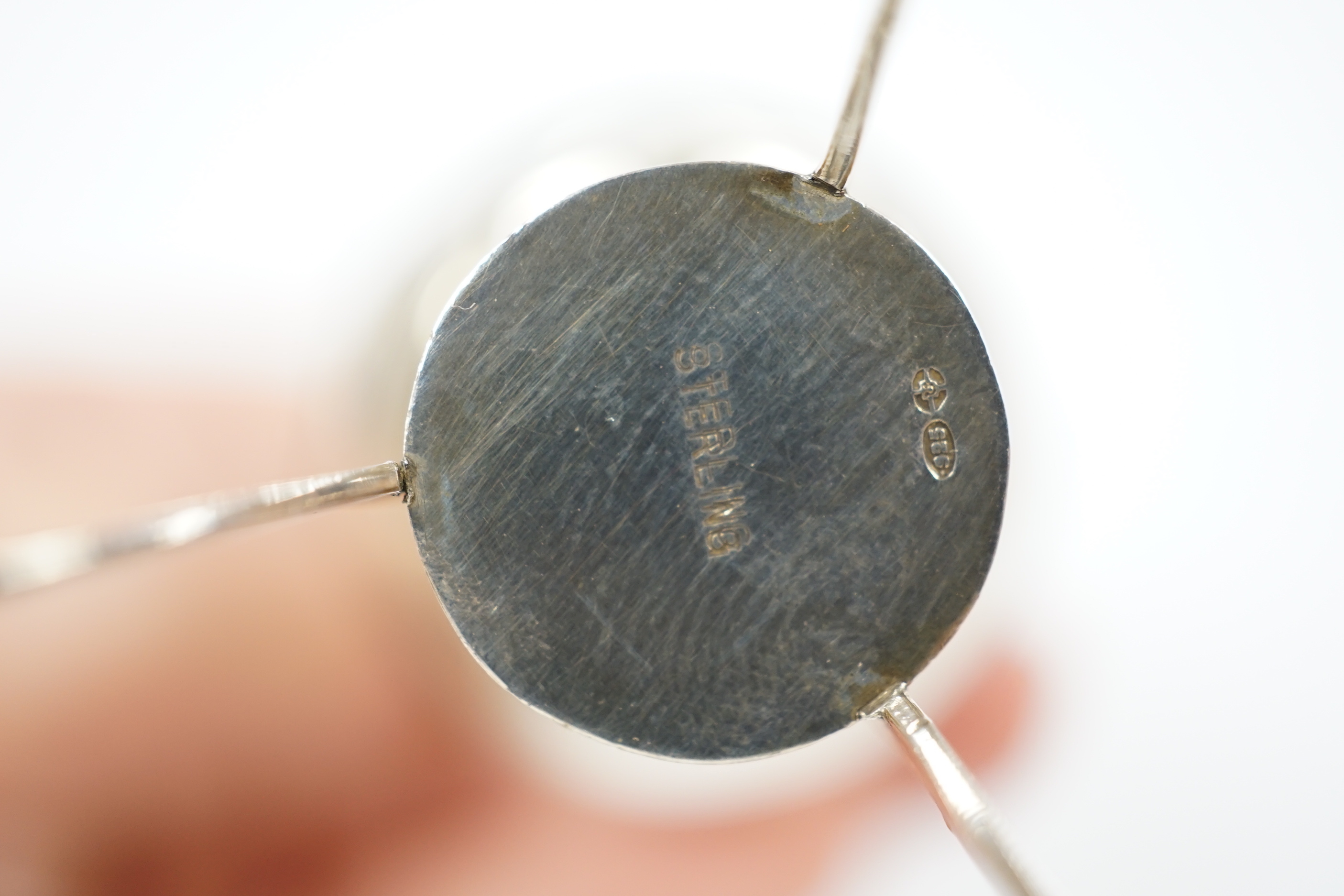 A 1920's continental silver pepperette, on tripod support, stamped sterling, import marks for London, 1920, 82mm.